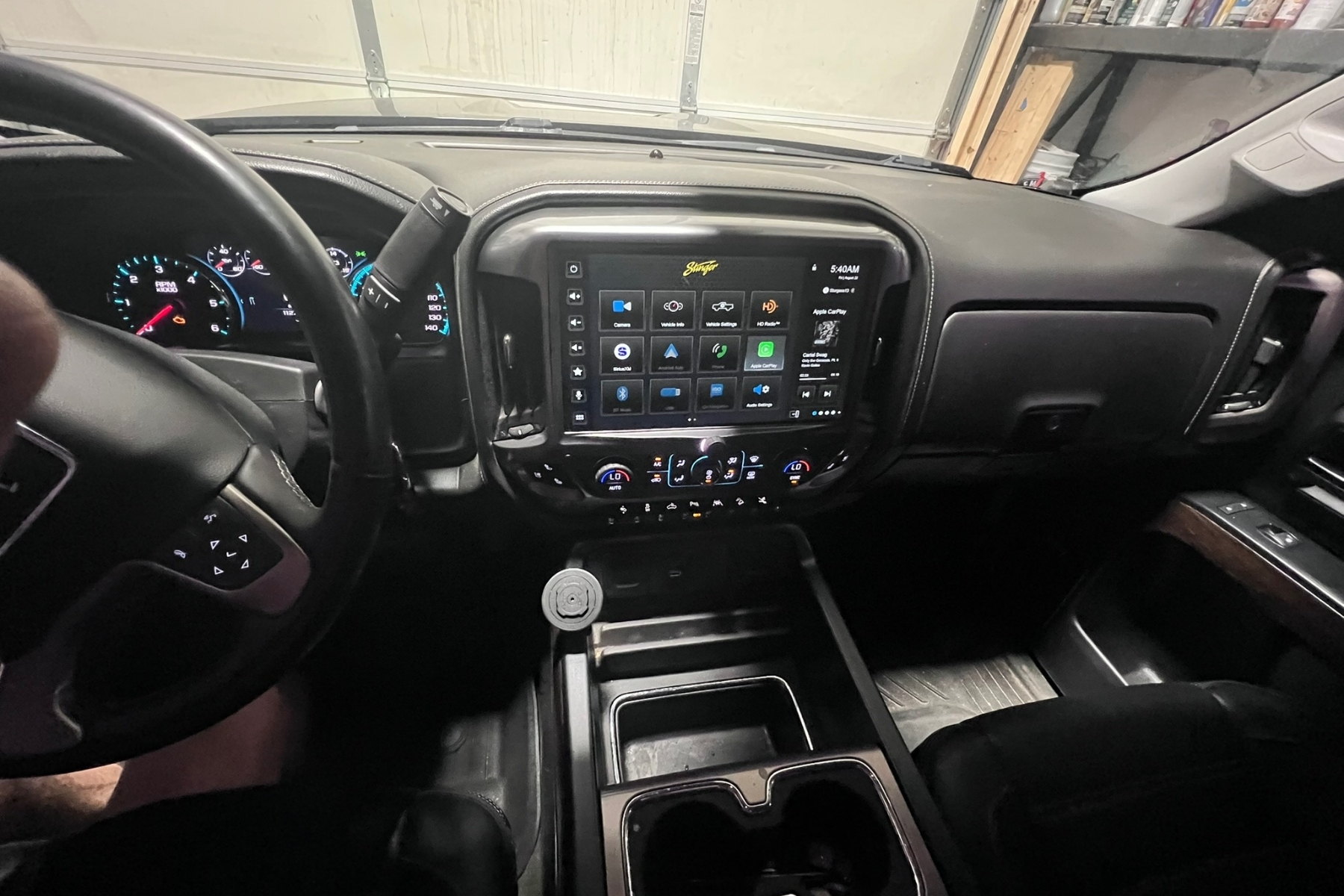 Aftermarket touchscreen in OEM-style dash kit, factory-correct fitment — installed by Sturgess Customs