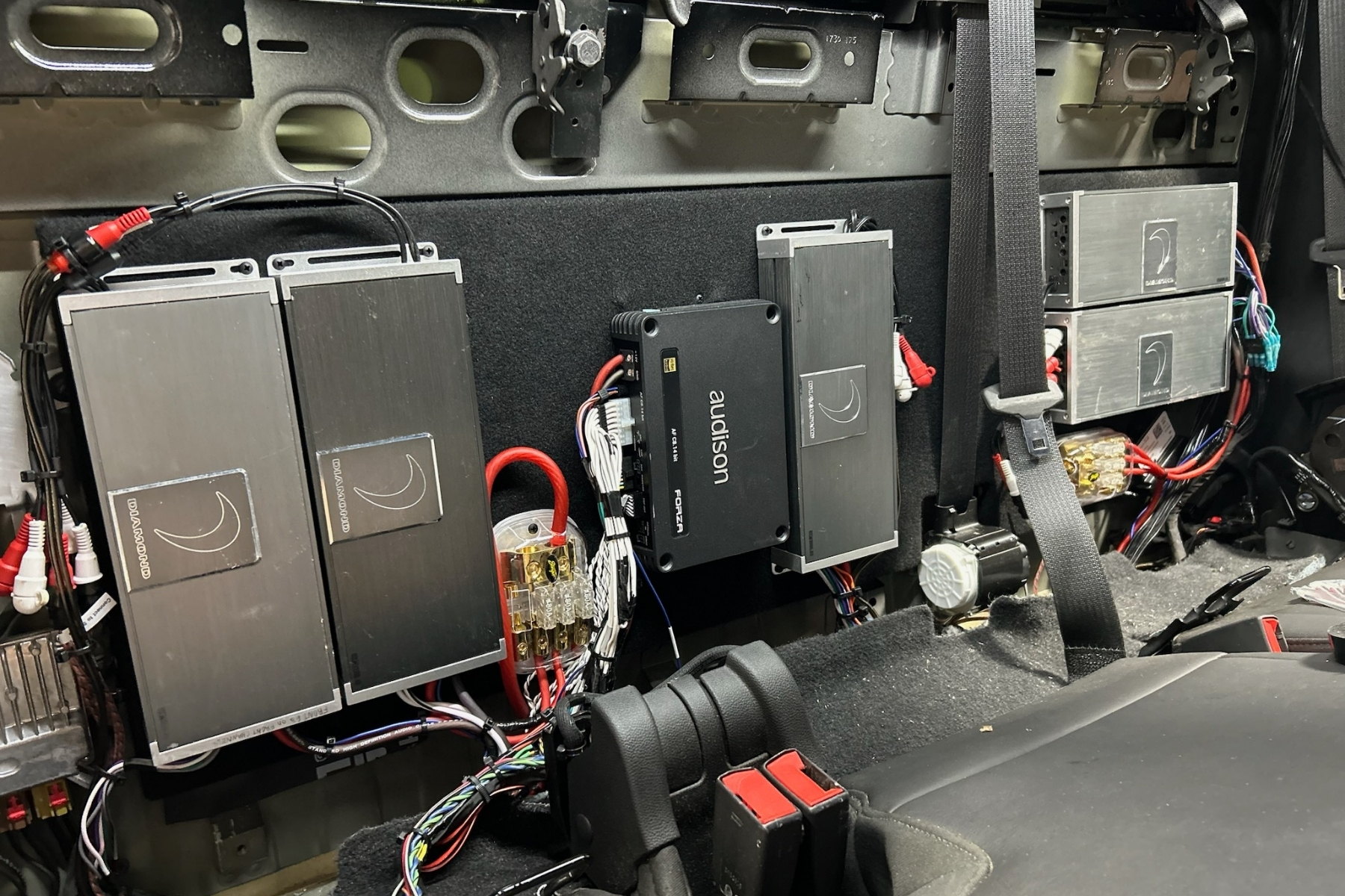 Clean amp rack, signal and power routed separately — installed by Sturgess Customs