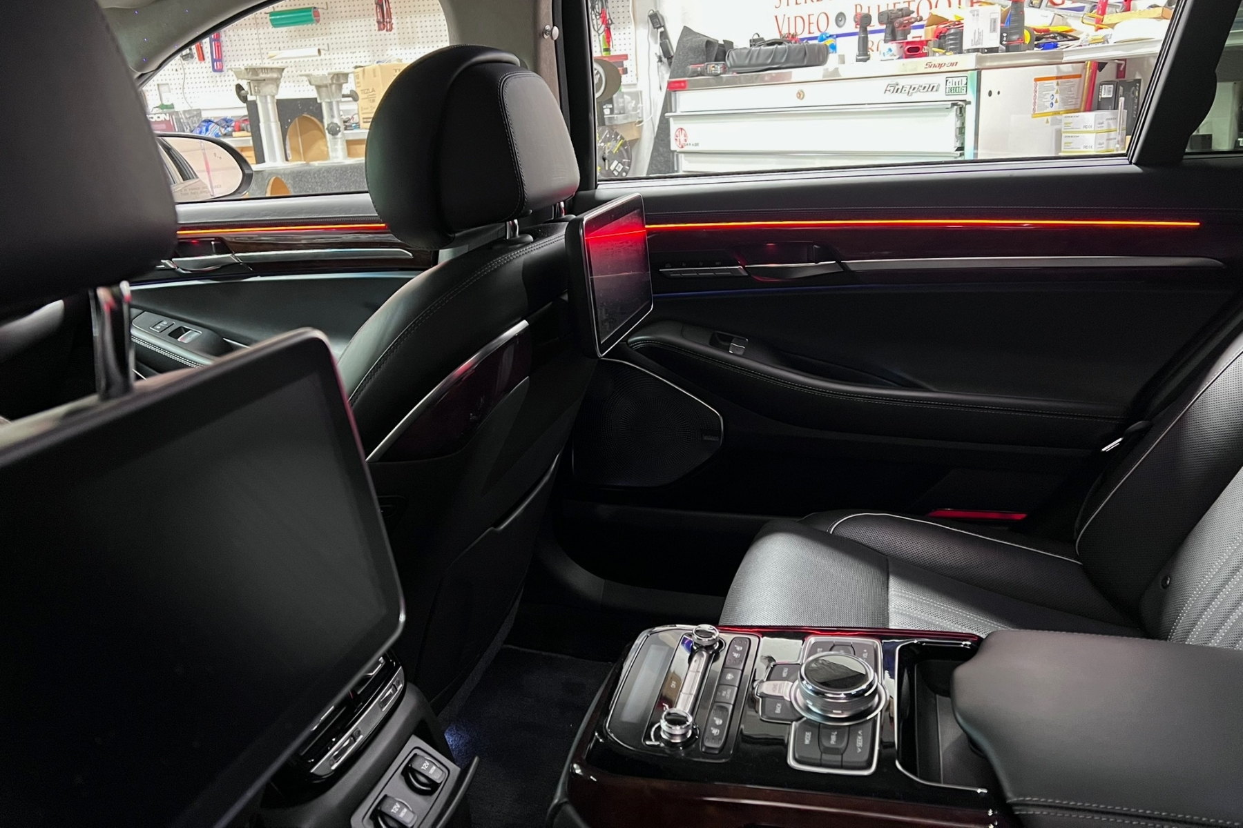 Headrest monitor or overhead system install — installed by Sturgess Customs