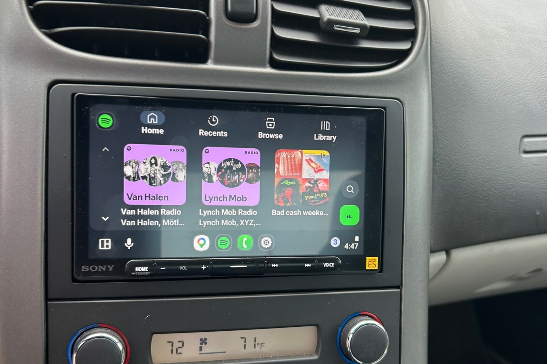 Android Auto running on the installed head unit with the factory dual-zone climate panel retained directly below &mdash; installed by Sturgess Customs