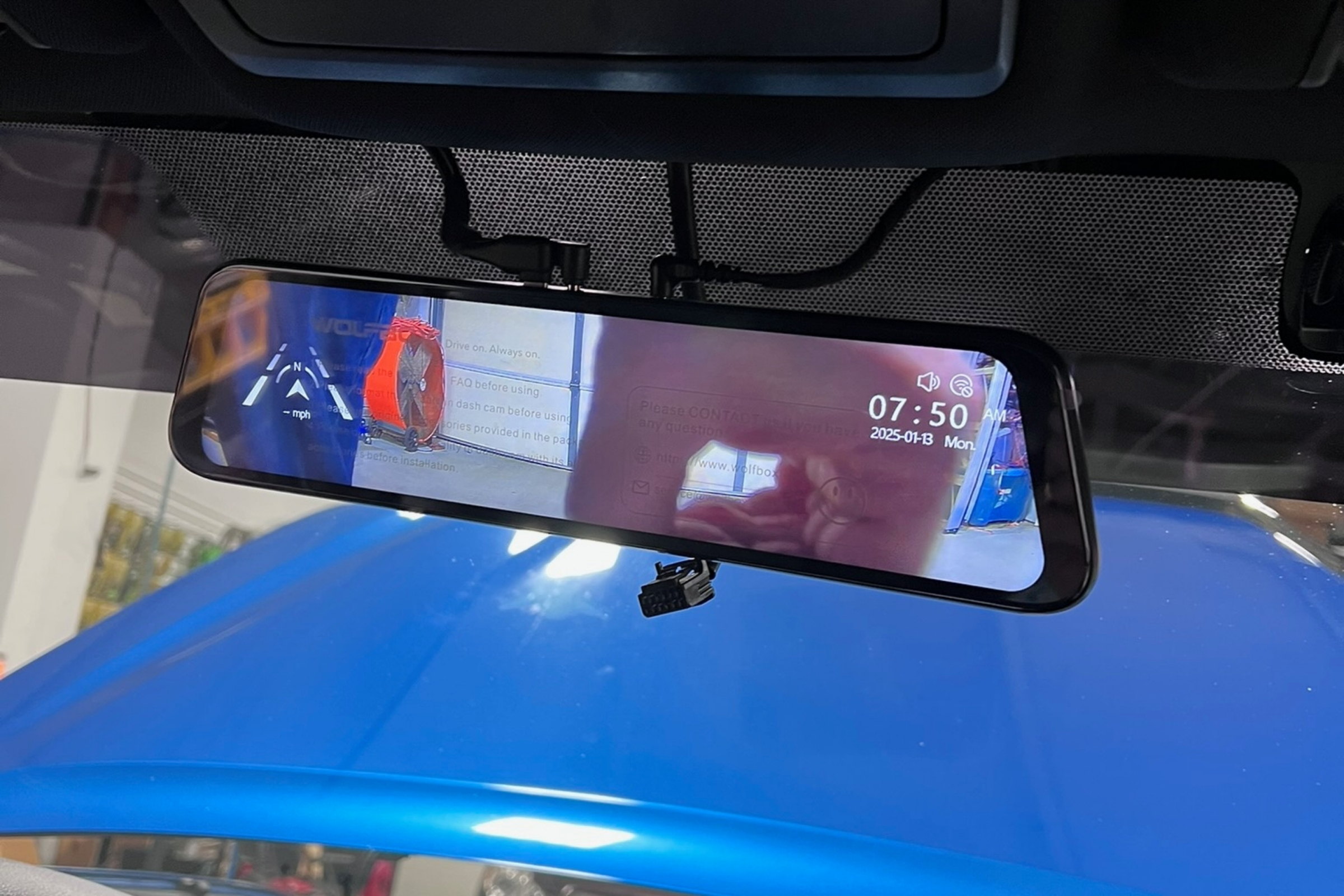 Dash cam at factory-correct mount position behind mirror, daytime — installed by Sturgess Customs