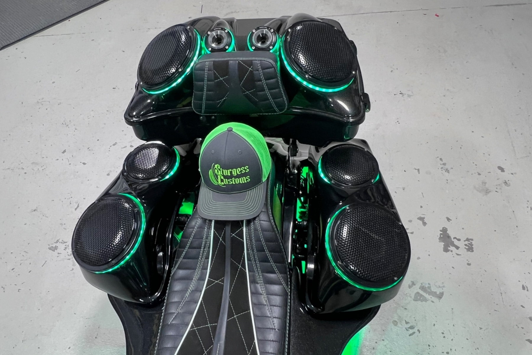 Lid-mounted or internal-baffle, cutout + sealing visible — installed by Sturgess Customs