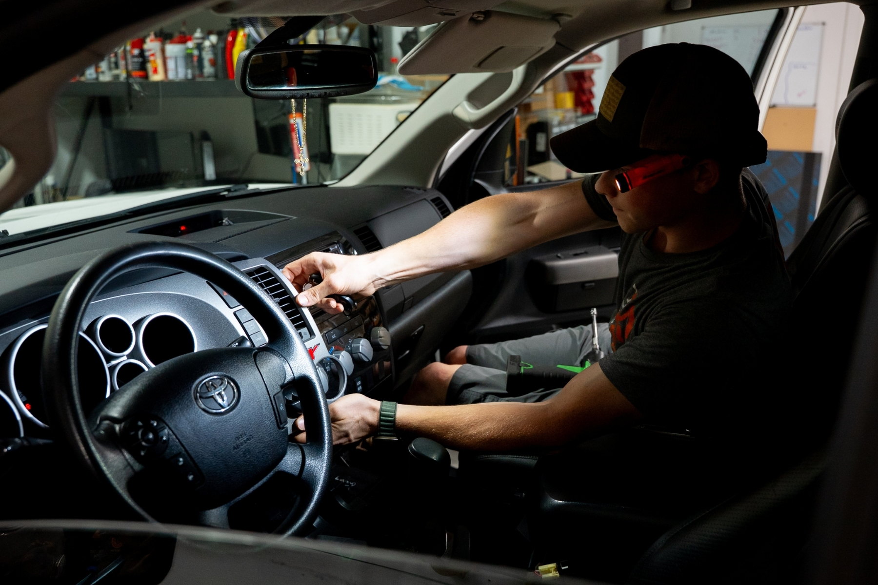 Technician checking a newly installed camera and display system at the dash before handing the vehicle back &mdash; Sturgess Customs