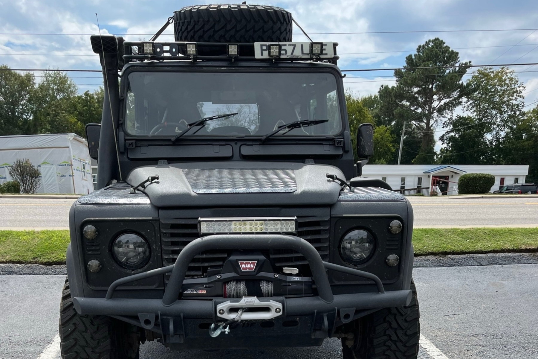 Off-road light bar mounted on a truck bumper, shown in daylight — installed by Sturgess Customs