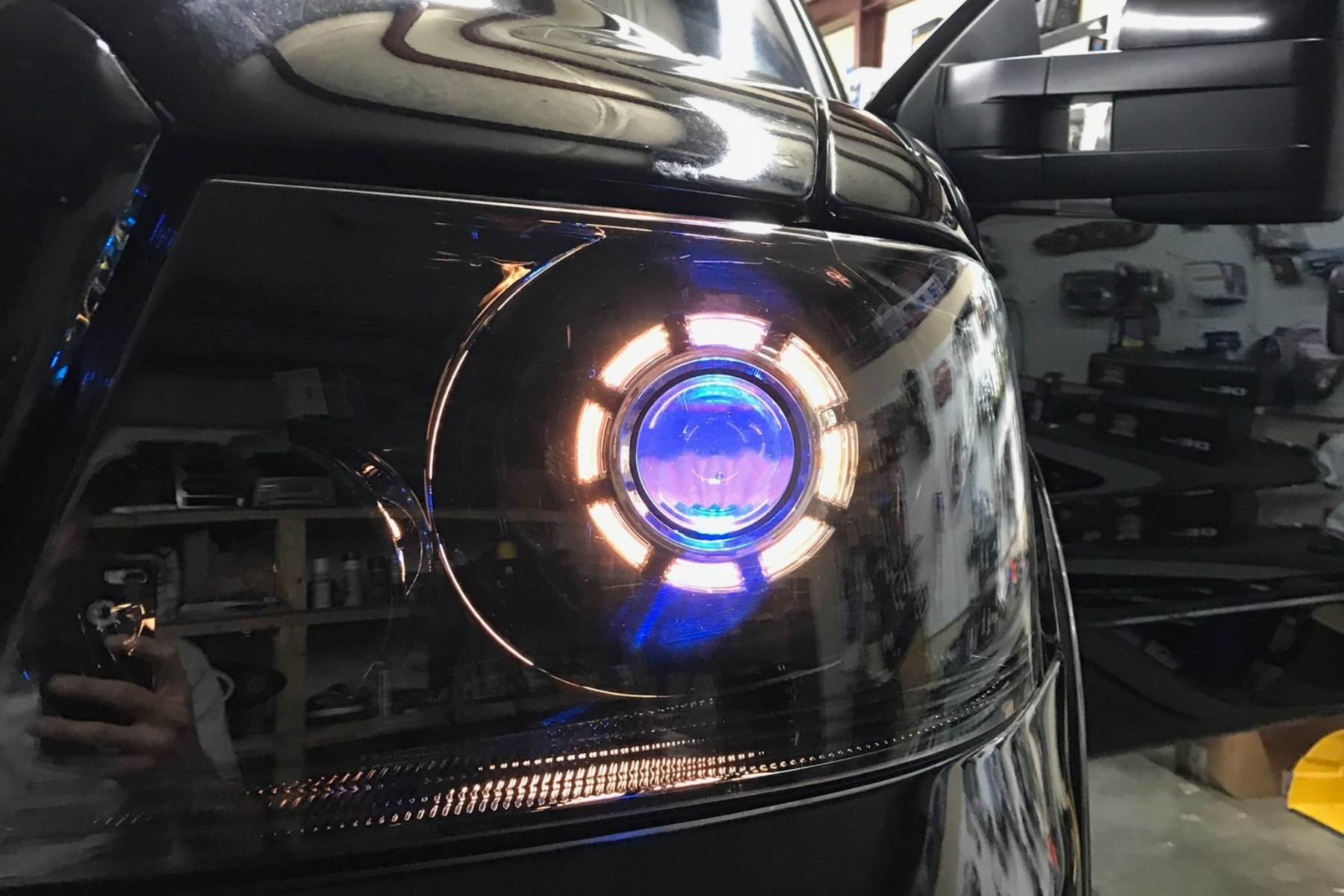 Halos visible in headlight assembly, front-end context, daylight or dawn/dusk — installed by Sturgess Customs