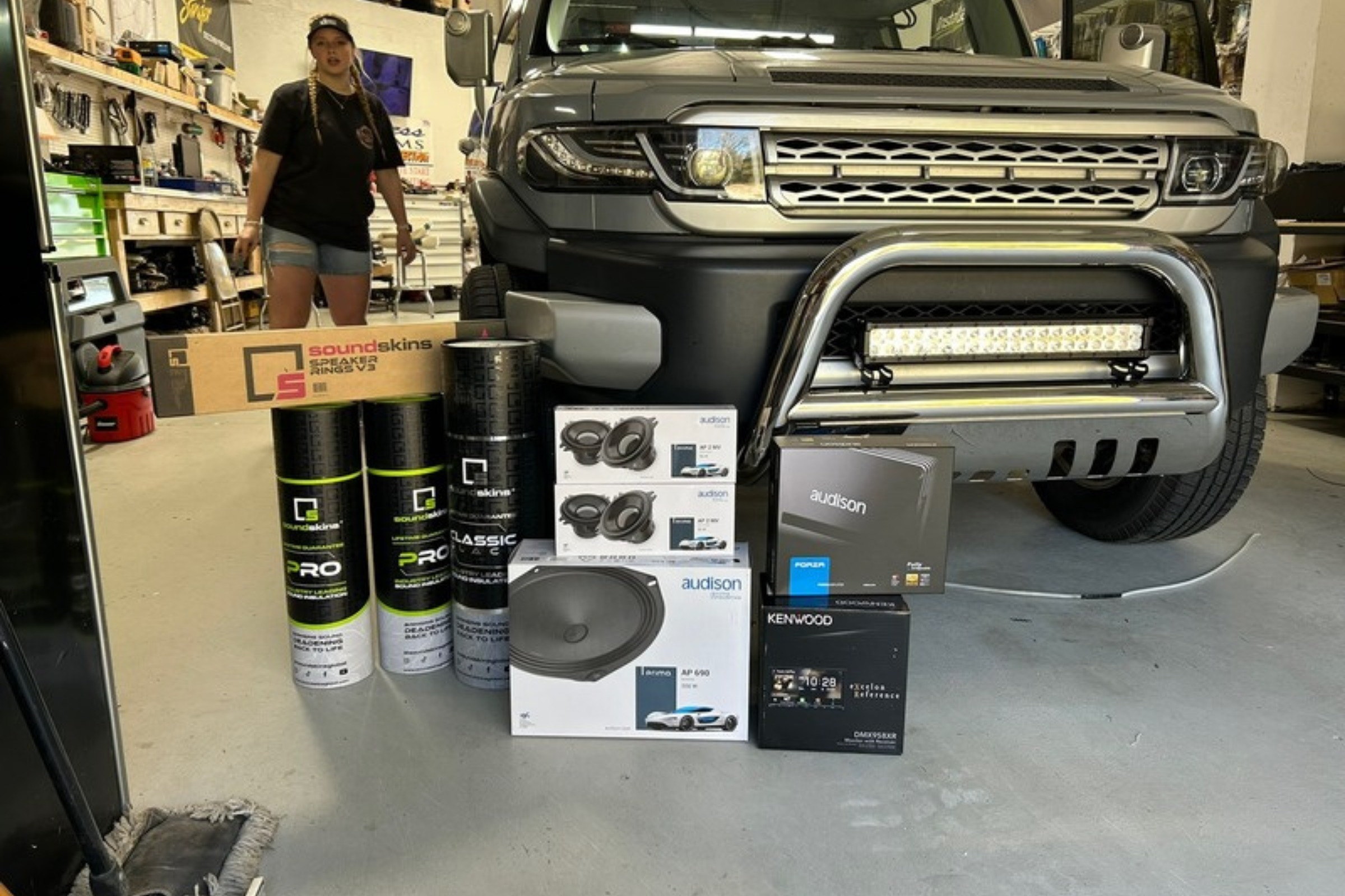 Light bar/rock lights on real truck, DAYLIGHT shop/driveway context — installed by Sturgess Customs