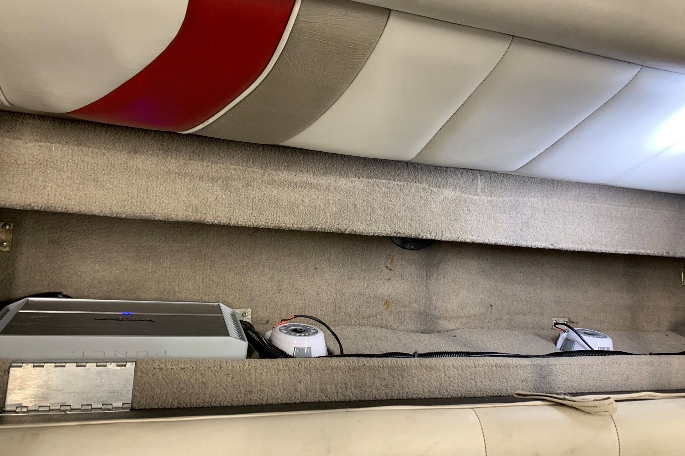 Amp in real marine compartment, ventilation visible — installed by Sturgess Customs